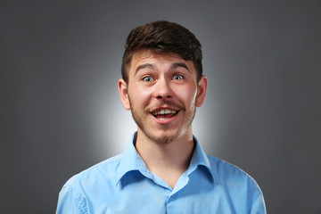 Portrait of surprised man on gray background