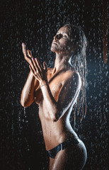 Fototapeta na wymiar Nude young woman in the rain