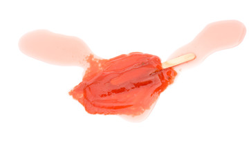 red popsicle melting completely on a white background