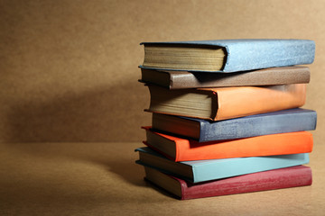 Old books on shelf, close-up, on wooden background