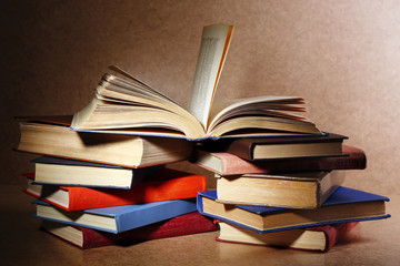 Old books on shelf, close-up, on wooden background