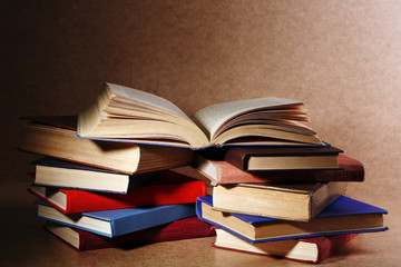 Old books on shelf, close-up, on wooden background
