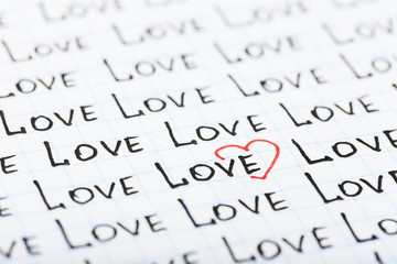 Words LOVE written on sheet of paper background
