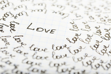 Words LOVE written on sheet of paper background