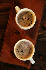 Cups of coffee on napkin on table close up