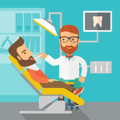 Dentist man examines a patient teeth in the clinic