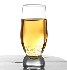 Glass of water with bubbles on table isolated on white