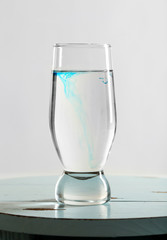 Glass of water on table on light background