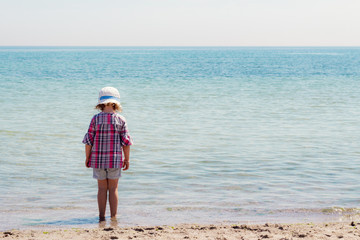 Funny little girl on the beach.