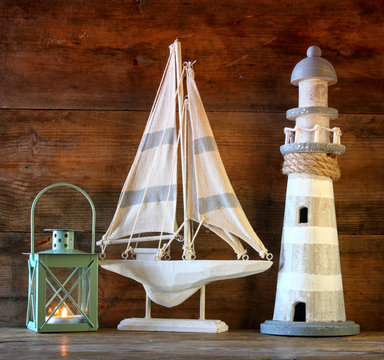 nautical lifestyle concept. old vintage lighthouse, sailing boat , lantern