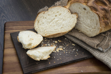 Freshly baked rustic loaf of bread in farmhouse setting with woo