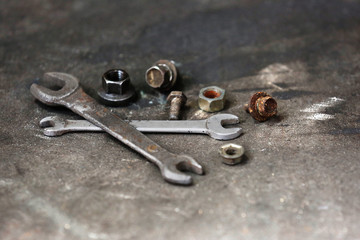 Wrenches and bolts on table close up