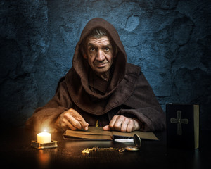 .Monk - priest.by candlelight - Bible reading - 87817608