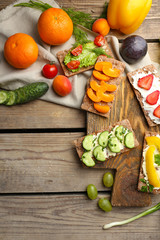 Still life with vegetarian sandwiches on wooden table