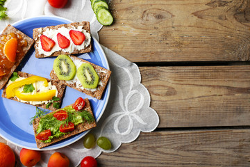 Still life with vegetarian sandwiches on wooden table