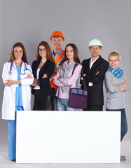 Portrait of smiling people with various occupations holding