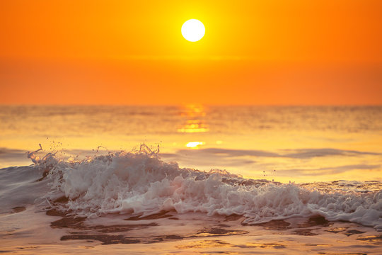 Sunrise and shining waves in ocean