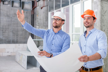 Handsome young builders are working on a new project