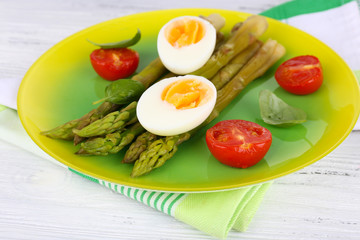 Plate of dietary salad with boiled asparagus and egg, closeup