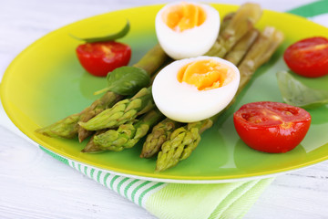 Plate of dietary salad with boiled asparagus and egg, closeup