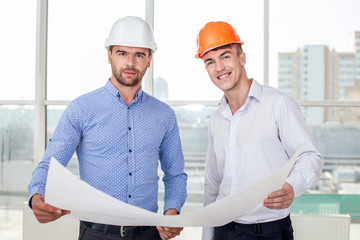 Handsome young builders are discussing a new project