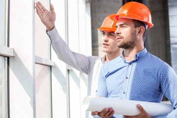 Handsome builders are discussing the plan of work