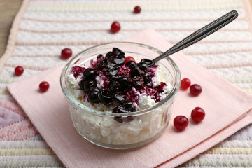 Cottage cheese with black canned currant on napkin table, closeup