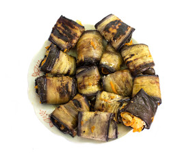 Rolls stuffed eggplant on a plate. Top view
