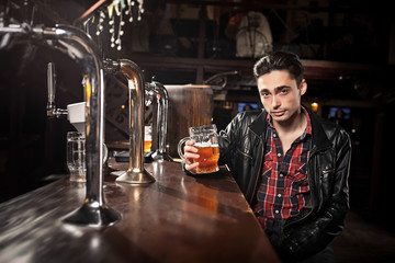 Man drinking beer in pub