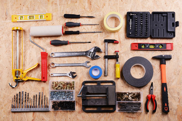 Set of tools on plywood, top view