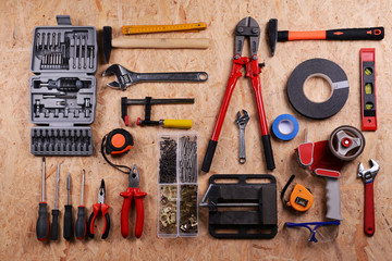 Set of tools on plywood, top view