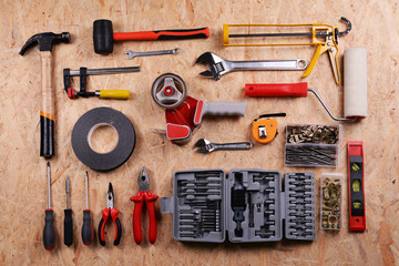 Set of tools on plywood, top view