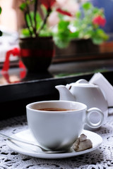 Hot chocolate in mug, on table, on bright background