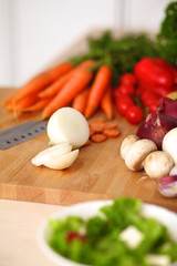 Young woman cutting vegetables in the kitchen