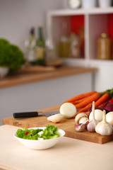 Young woman cutting vegetables in the kitchen