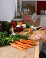 Young woman cutting vegetables in the kitchen
