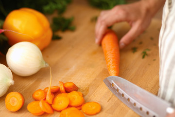 Young woman cutting vegetables in the kitchen