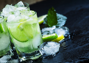 Lemon-lime green drink with crushed ice on a dark background, se
