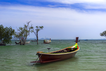 Naklejka na ściany i meble Fisherman Long Tail Boat in Koh Mook Coast Line.