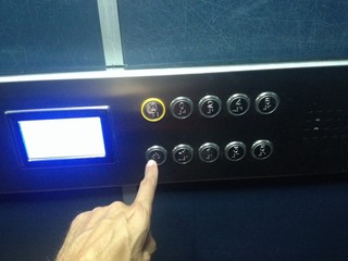 hand press button in elevator