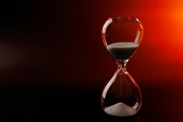 Hourglass on dark color background
