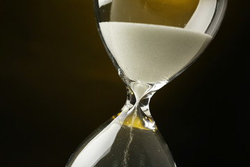 Hourglass on dark yellow background