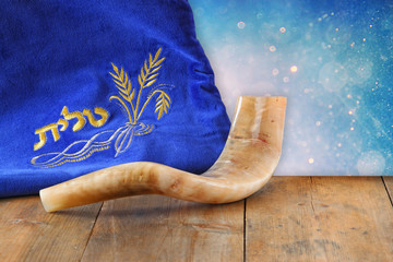 image of shofar (horn) and prayer case with word talit (prayer)