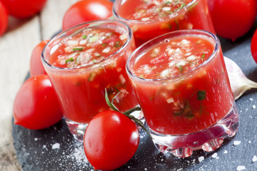 Tomato juice with vegetables and fresh tomato on dark stone back