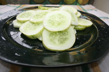 Cucumber sliced with fresh herbs on a plate