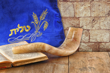image of shofar (horn) and prayer case with word talit (prayer)