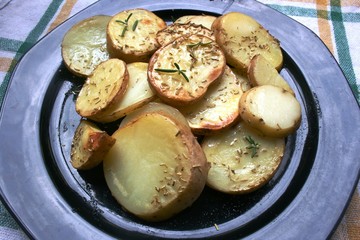 Baked potato on the plate with spices