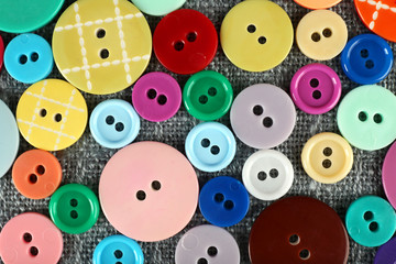 Colorful buttons on sackcloth, closeup