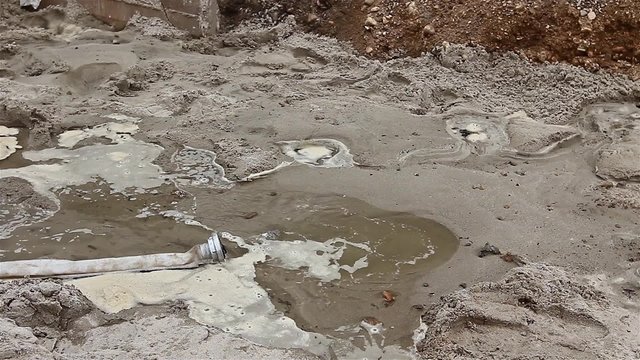 Sand absorbs water. After backfilling the trench sand is watering with water.
