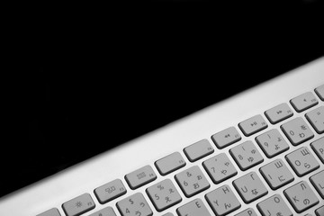 Close-up Of Multilingual  Wireless Keyboard Isolated On Black Ba